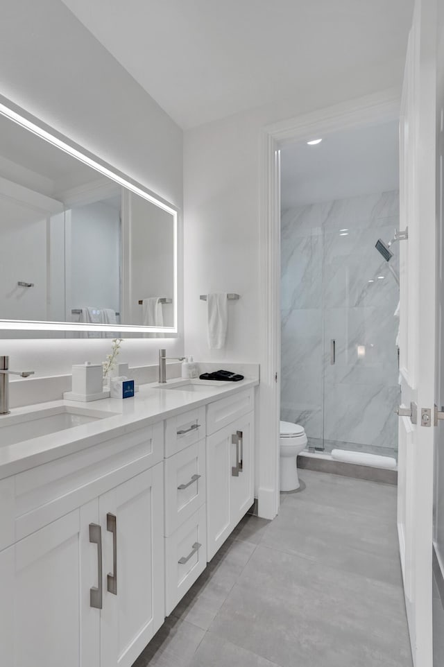 bathroom featuring vanity, toilet, and a shower with shower door