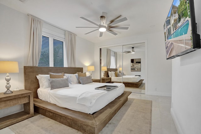 tiled bedroom with ceiling fan and a closet