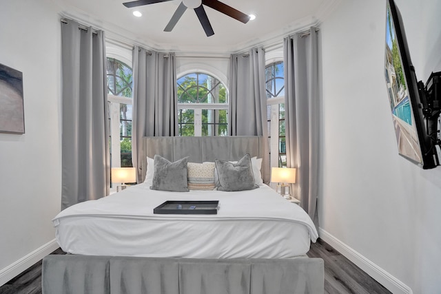 bedroom with ceiling fan, dark wood-type flooring, and ornamental molding