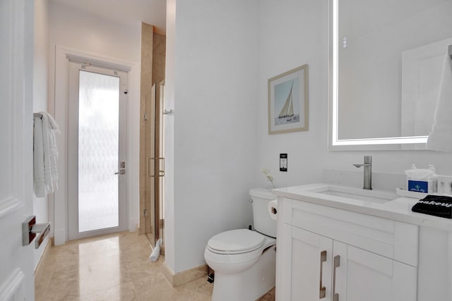 bathroom featuring vanity, toilet, and walk in shower