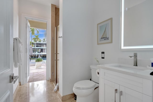 bathroom with tile patterned floors, vanity, and toilet