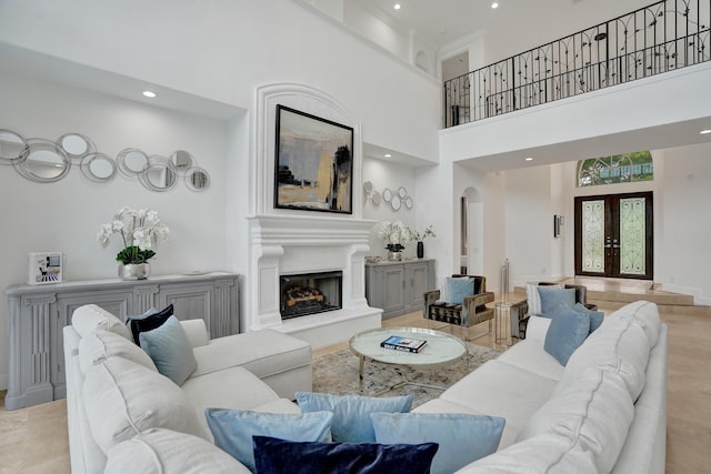 living room featuring french doors and a towering ceiling