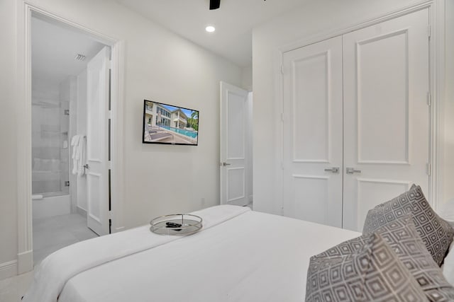 bedroom featuring connected bathroom, a closet, and ceiling fan