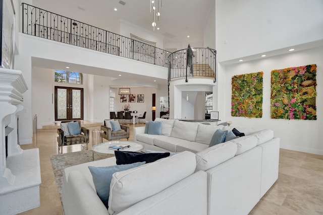 living room featuring a towering ceiling and french doors