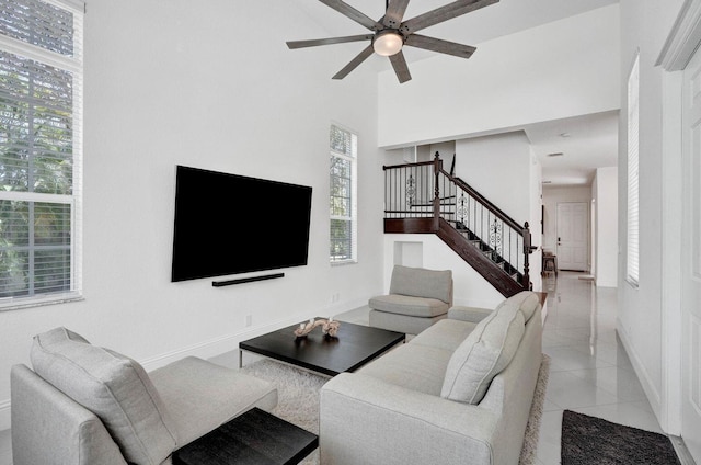 tiled living room with ceiling fan and plenty of natural light