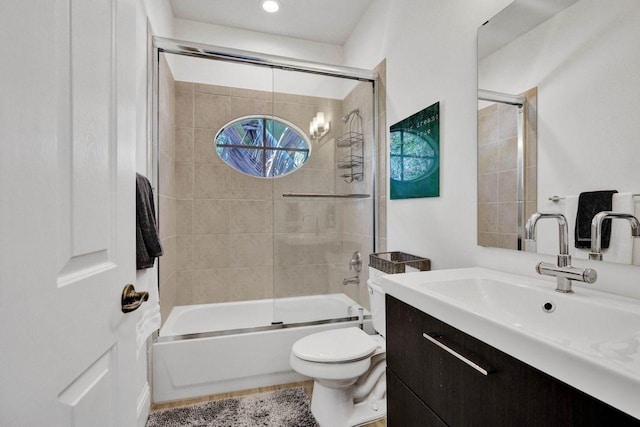 full bathroom featuring vanity, toilet, and enclosed tub / shower combo