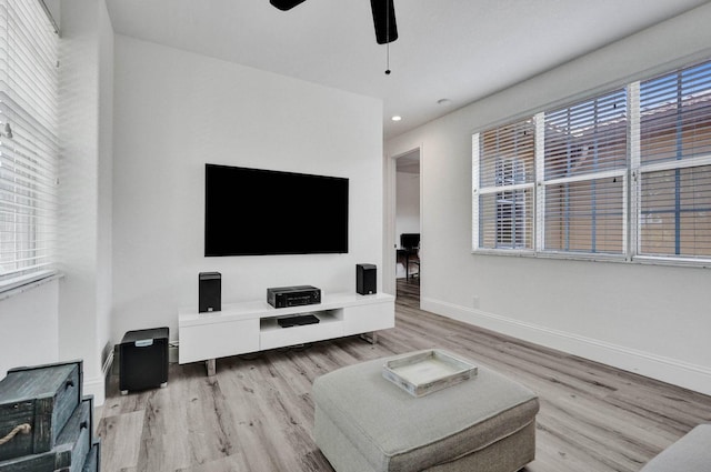 living room featuring ceiling fan and light wood-type flooring