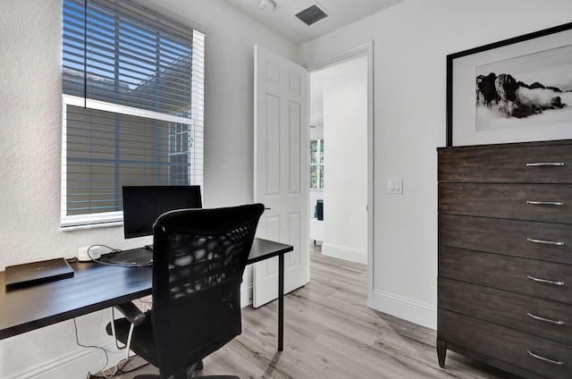 office area with light hardwood / wood-style floors