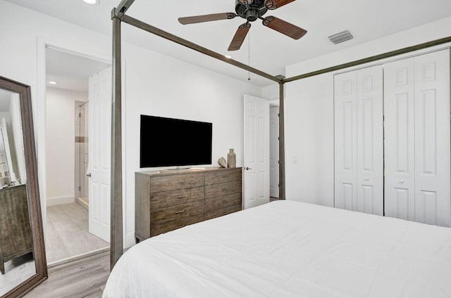 bedroom with a closet, ceiling fan, and light hardwood / wood-style flooring