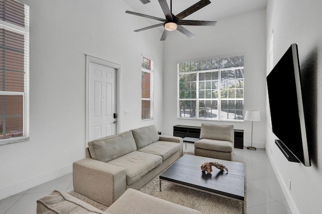 living room featuring ceiling fan, light tile patterned flooring, and high vaulted ceiling