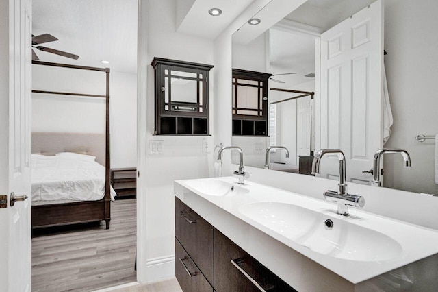 bathroom featuring ceiling fan, vanity, and hardwood / wood-style flooring