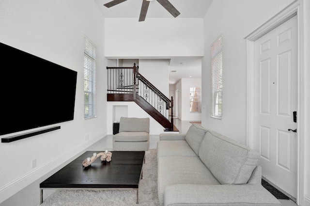 living room featuring a high ceiling and ceiling fan