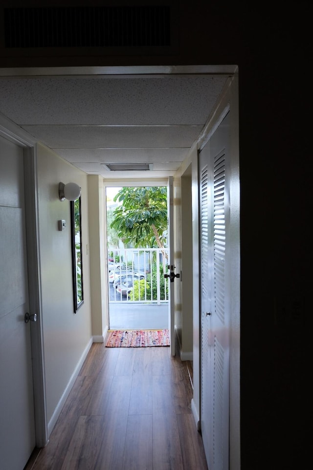 hall with hardwood / wood-style floors