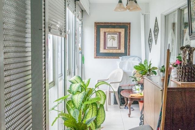 hallway featuring light tile patterned floors and plenty of natural light