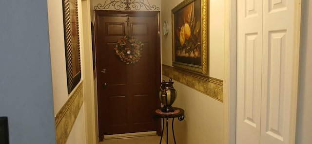 doorway to outside with light tile patterned flooring