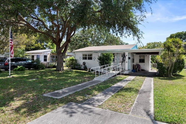 ranch-style house featuring a carport and a front yard