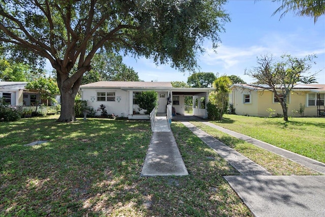 single story home with a front lawn and a carport