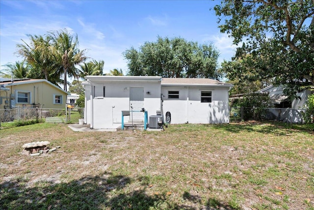 back of house with a yard and cooling unit