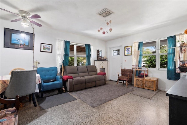 living room with plenty of natural light and ceiling fan