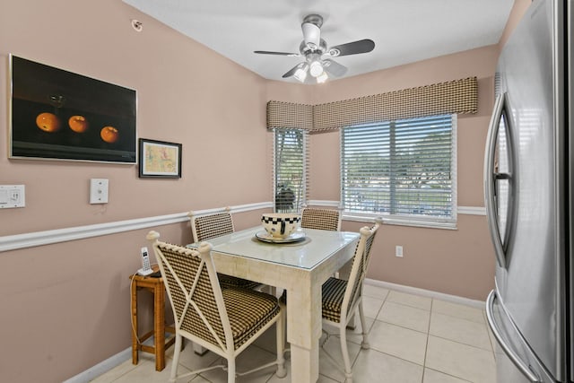 tiled dining space with ceiling fan