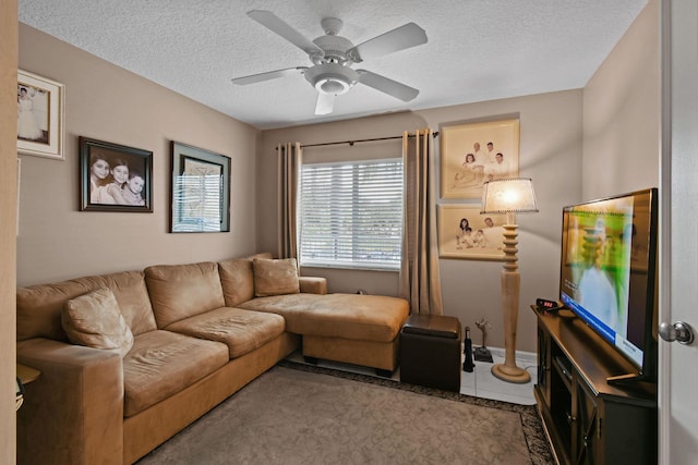 living room with tile patterned floors, ceiling fan, and a textured ceiling