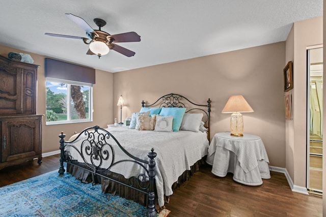 bedroom featuring ceiling fan, dark hardwood / wood-style floors, and ensuite bathroom