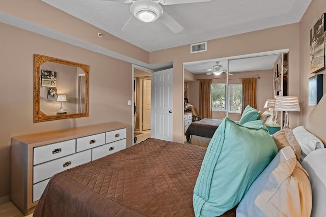 bedroom with ceiling fan, a textured ceiling, and a closet