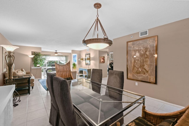 dining area featuring ceiling fan and light tile patterned flooring