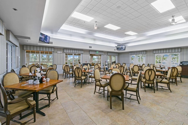 dining room featuring a tray ceiling and ceiling fan