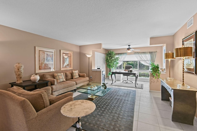 tiled living room with a textured ceiling and ceiling fan