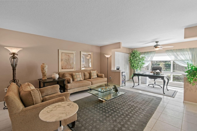 tiled living room with ceiling fan and a textured ceiling