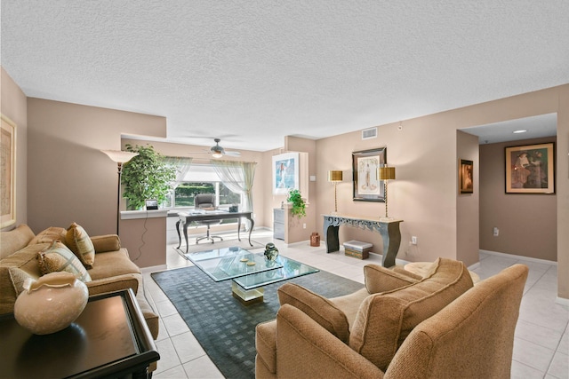 tiled living room featuring a textured ceiling