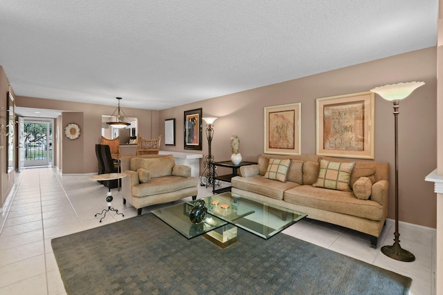 living room with light tile patterned floors and a textured ceiling