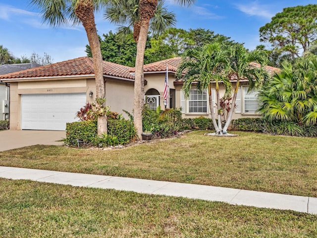 mediterranean / spanish house featuring a front lawn and a garage