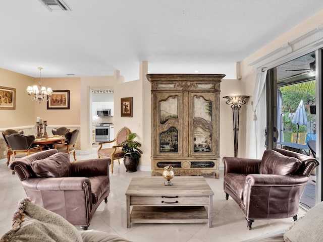 living room featuring a chandelier and light tile patterned floors