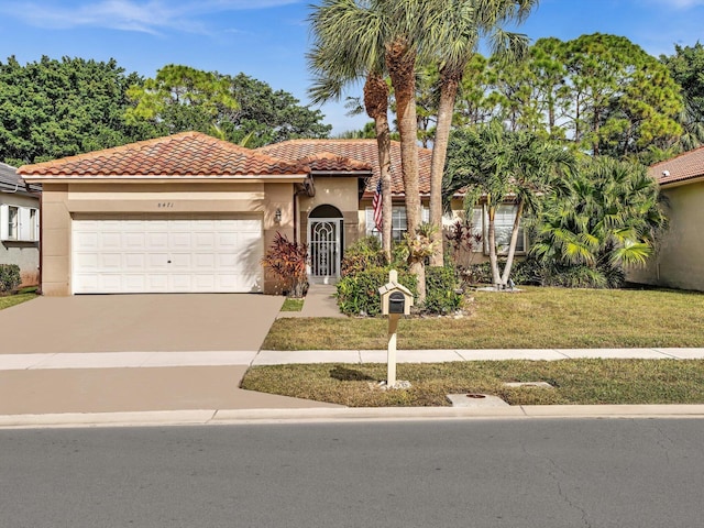 mediterranean / spanish-style home with a garage and a front yard