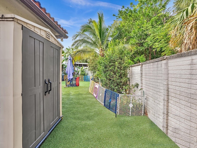 view of yard with a playground and a storage shed