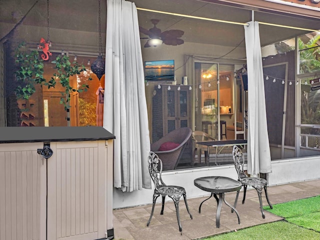 view of patio with radiator and a sunroom