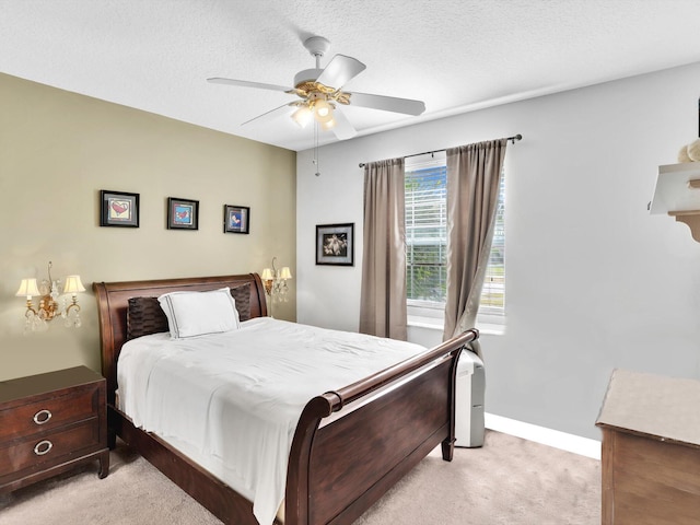 carpeted bedroom with a textured ceiling and ceiling fan