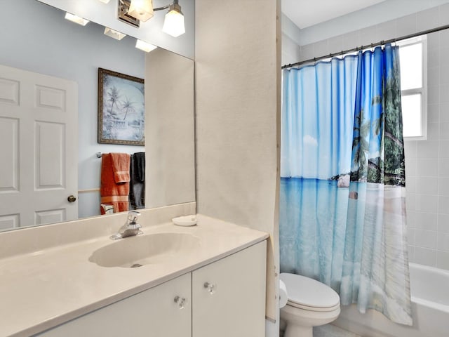 full bathroom featuring vanity, shower / tub combo, and toilet