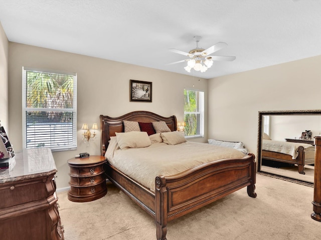 bedroom featuring ceiling fan and light carpet