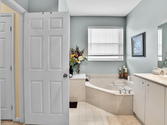 bathroom with tile patterned floors, vanity, and a bathing tub