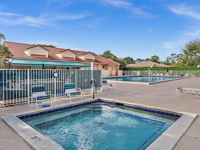 view of swimming pool featuring a community hot tub