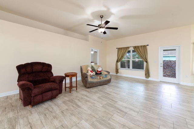 living area with ceiling fan and light hardwood / wood-style floors