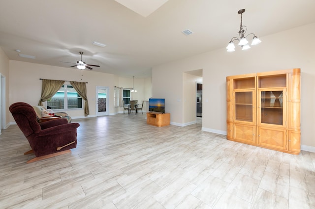 unfurnished living room featuring ceiling fan with notable chandelier