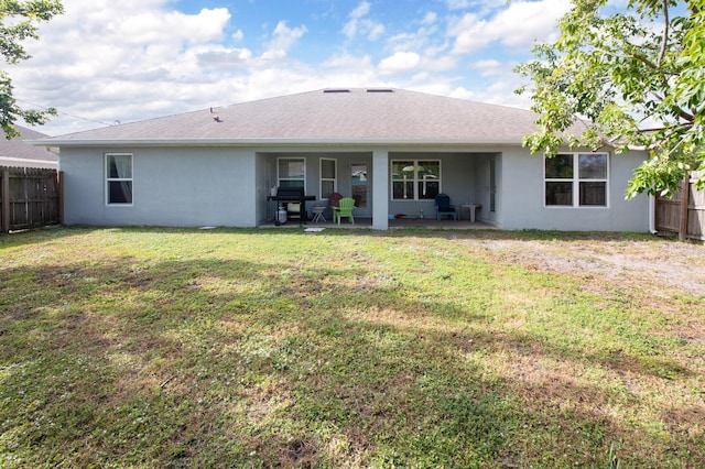 back of house with a yard