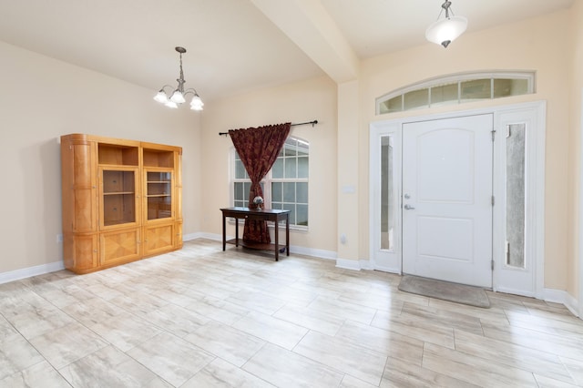 foyer featuring a chandelier