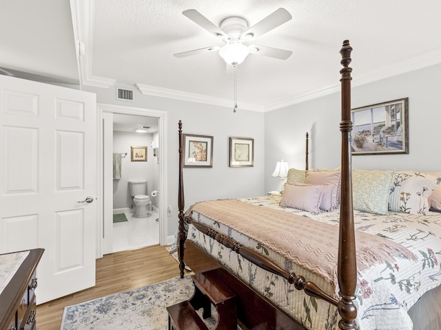 bedroom with ornamental molding, a textured ceiling, ceiling fan, hardwood / wood-style floors, and connected bathroom