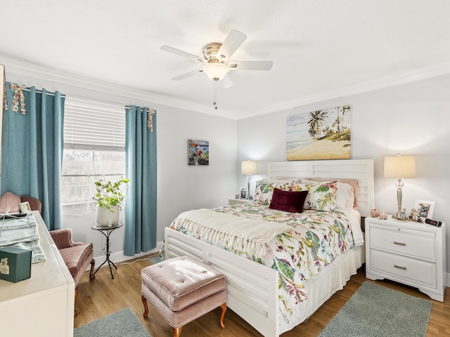 bedroom with hardwood / wood-style floors, ceiling fan, and crown molding