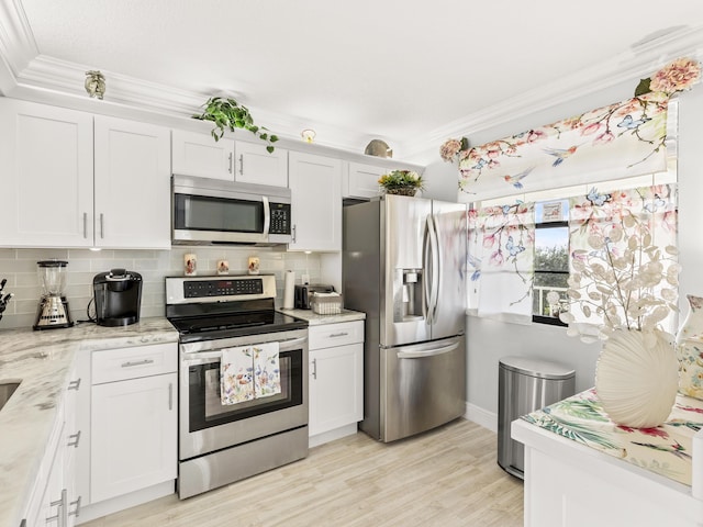 kitchen with backsplash, white cabinetry, and appliances with stainless steel finishes